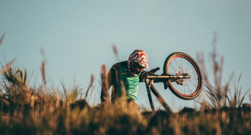 Biker Carrying His Mountain Bike